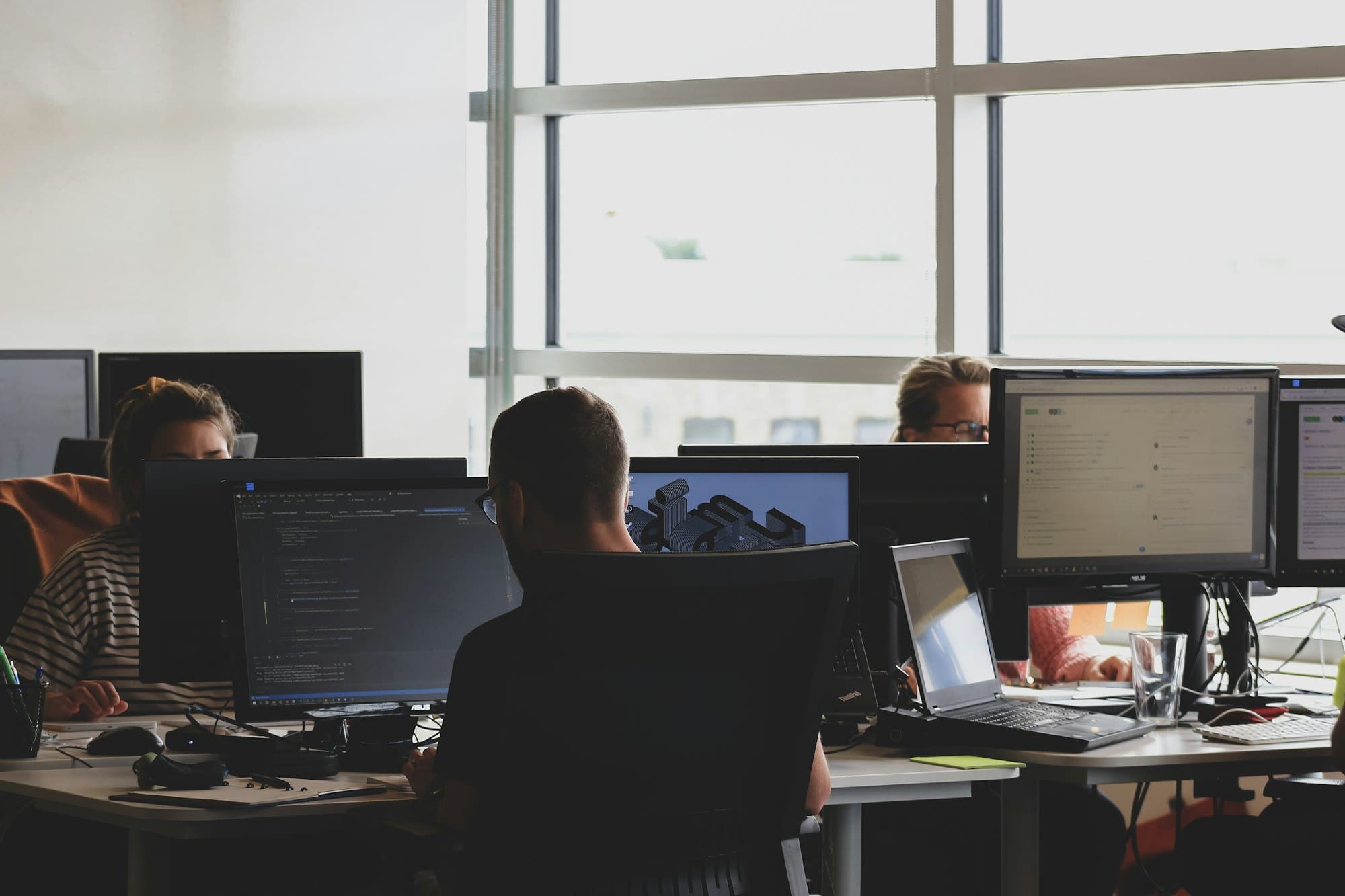 Team working in front of monitors in an office