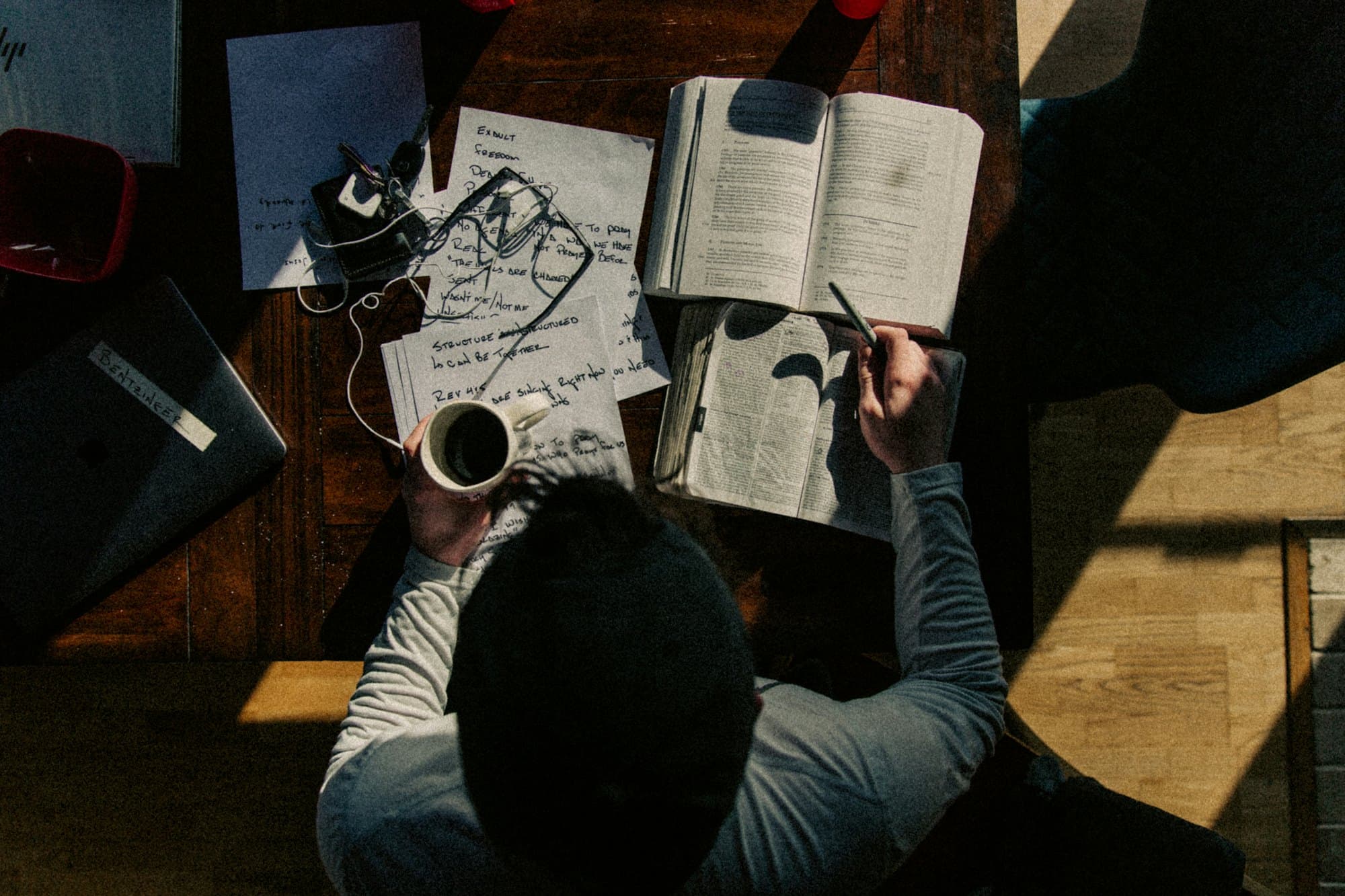 Person taking notes at a work table